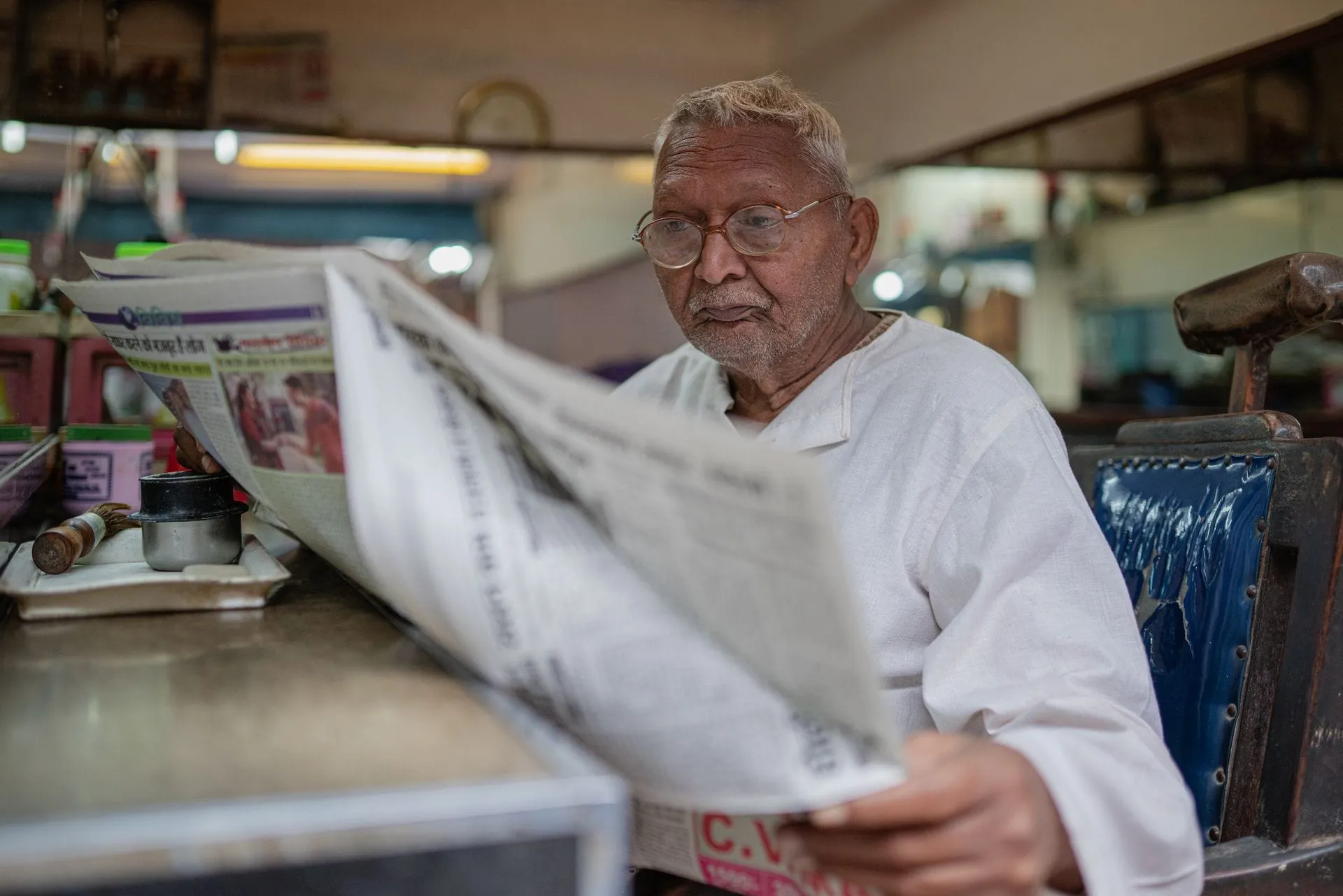 Man reading a newspaper in Varanasi, India